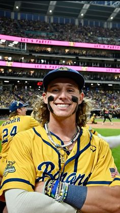 a man with his face painted like a baseball player at a game in a stadium