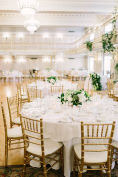 the tables are set with white and green centerpieces for an elegant wedding reception