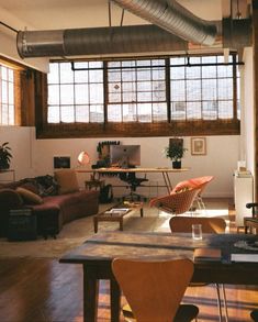 a living room filled with furniture and lots of windows