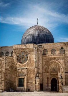 an old stone building with a dome on top