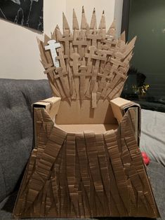 a cardboard game of throne sitting on top of a couch