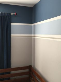 a bedroom with blue and white striped walls