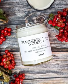 cranberry woods soy candle surrounded by berries