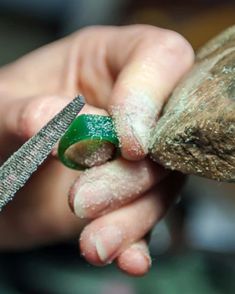 a person is holding something in their hand with a green object sticking out of it