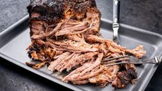 a plate with some meat on it and a fork next to it, ready to be eaten