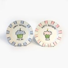 two birthday plates with cupcakes on them