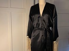 a black robe with gold fringes on it