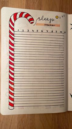 an open notebook with a candy cane on it