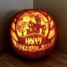 a carved pumpkin with the words happy halloween on it's face and an image of a house