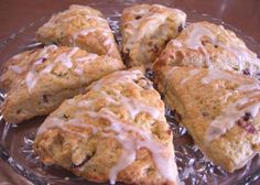 scones with icing sitting on top of a glass plate