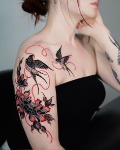 a woman with tattoos on her arm and shoulder