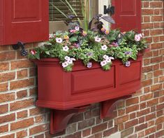 a red window box with flowers in it