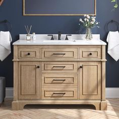 a bathroom with blue walls and wooden cabinets