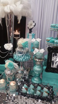 a table topped with lots of blue and silver items