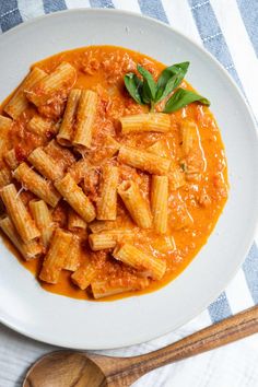 a white bowl filled with pasta and sauce