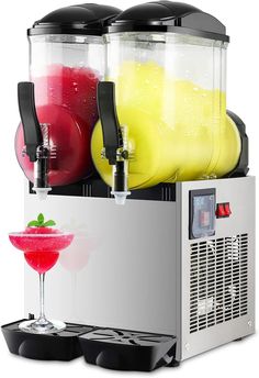 a machine that is filled with drinks and garnished with fruit on the side