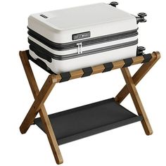 a large white and black cooler sitting on top of a wooden stand with two legs