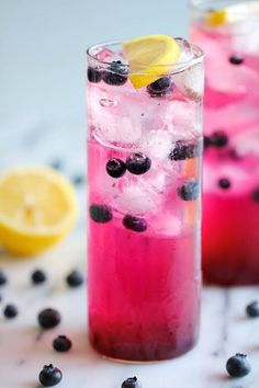 two glasses filled with blueberries and lemonade