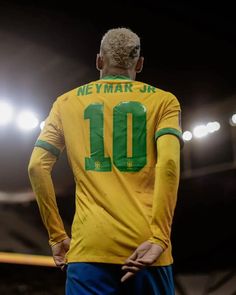 a soccer player wearing a yellow and green uniform with the number 10 on it's chest