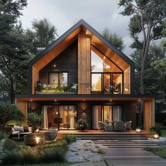 a large house with lots of windows and lights on the front, surrounded by greenery