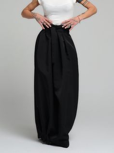 Make a bold statement with our high-waist skirt, the epitome of tailored elegance. This skirt is fashioned from premium polyester, delivering a smooth finish with a substantial feel that gracefully flows with every step. The design is accentuated by a tasteful belt that cinches the waist, while the elasticated back ensures a snug and comfortable fit. Its voluminous silhouette and sleek lines make it a versatile piece for both office wear and evening affairs. FEATURES:Includes a chic belt, elasticated back for comfort, and a high-waist cut 100% Handmade. SIZE & FIT: Fit: A relaxed fit with room to moveModel is wearing size Small or S/M View our SIZE CHART before ordering MATERIALS & CARE: Content: Polyester Care: Dry cleaning only SHIPPING: Made to order, processing time is 15 working days A Perfect Marriage, Chic Belt, Set Clothes, Perfect Marriage, Locker Room, Loungewear Set, Workout Sweatshirt, Office Wear, Comfort Zone