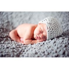 a sleeping baby wearing a crochet hat