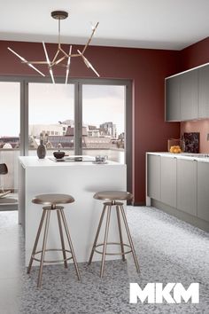 a kitchen with two bar stools next to an open floor plan and large windows