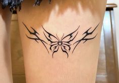 a woman's leg with a butterfly tattoo on it