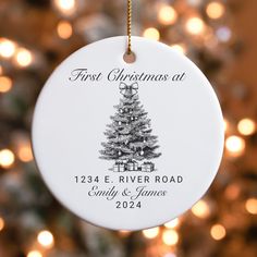 a white ornament hanging from a christmas tree