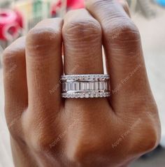 a woman's hand with a wedding ring on it