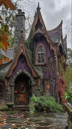 a purple and brown house surrounded by leaves