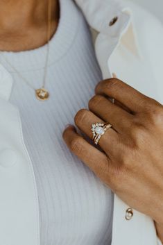 a close up of a person wearing a diamond ring