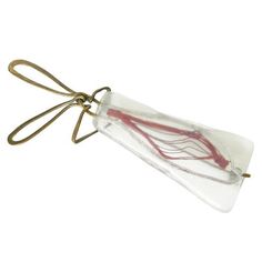 a small plastic bag with red string attached to it's side on a white background