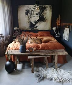 a bedroom with an orange bed and black walls