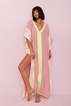 A spinoff on one of our fan favorites, the Thobe, this Contrast Striped Thobe features a delicate hand-loomed fabric in a light and breezy silhouette, with a V-neckline and an elegant contrasting striped pattern throughout the bodice. Striped Kaftan For Summer Beach Cover-up, Beach Dresses With Vertical Stripes And V-neck, Striped Kaftan For Spring Vacation, Vertical Stripes V-neck Vacation Dresses, Striped V-neck Lined Dresses, Bohemian Striped Kaftan For Summer, Pink V-neck Kaftan For Spring, Spring Striped Kaftan For Beach Cover-up, Beach Dresses With Vertical Stripes