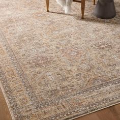 an area rug is shown with a wooden table and chair in the foreground, along with a vase on the floor