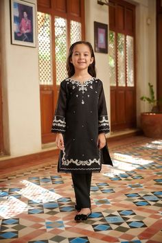 2-Piece Embroidered Suit for Girls (shirt & trouser only) : A classic state-of-the-art monochromatic design envisioning captivating details that make this two-piece staple a perfect style statement your daughter. Description -- Kameez (Shirt) : Paper Cotton shirt. Lining included. -- Shalwar (Trouser) : Black Pants. General Care Instruction : Should be hand washed and hung to dry. Color may bleed so please be mindful of other items with it. General Disclaimer -- Size chart provides reference siz Festive Cotton Sets With Embroidered Sleeves, Cotton Set With Embroidered Sleeves For Eid, Black Sets With Embroidered Sleeves For Eid, Black Festive Set With Embroidered Sleeves, Festive Black Set With Embroidered Sleeves, Black Sets With Embroidered Sleeves For Festive Occasions, Festive Unstitched Sets With Embroidered Sleeves, Unstitched Sets With Embroidered Sleeves For Festive Occasions, Fitted Cotton Sets With Embroidered Sleeves