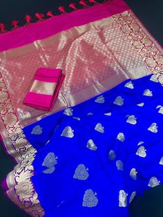 Stunning Saree!! Royal Blue body with Purple borders and Hot Pink Pallu. Double Lotus Flower on the borders with Zari Work while the flower buttas on the body are golden Zari Work. Super Soft Saree. Tassles at to the beauty of the Saree. Width of Border - 7 inches Item : Saree Color : Royal Blue, Purple and Hot Pink Base Fabric : Banarasi Silk Blouse piece : Comes with Blouse piece Blouse material : Banarasi Silk Fall & Edging: Comes with Fall and edging (Pico) and tassels attached Disclaimer -: - Color variation is possible due to various reasons like phone or desktop setting, resolution etc. Please don't hold us responsible. Our aim is to put the exact color of the Saree. - If the Saree is Pure Silk, we will put it very clearly in our listing that it is Pure Silk. If we do not mention it Blue Silk Saree, Saree Floral, Blouse Material, Handloom Saree, Blouse Piece, Silk Blouse, Royal Blue, Silk Sarees, Lotus