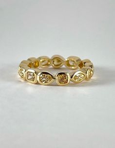 a yellow gold ring with three diamonds on it