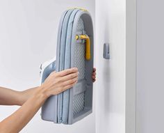 a person is holding onto the handle of a wall mounted towel dispenser