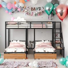 two bunk beds in a room with balloons on the wall