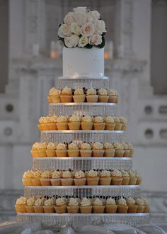 a wedding cake with cupcakes stacked on it