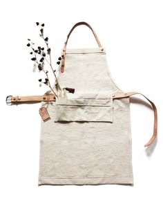 a white apron with flowers on it