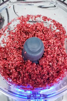 a food processor filled with lots of red stuff