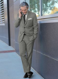 Redefine your style with the Loro Piana Marcela Wool Suit, an absolute showstopper. Made from luxurious pure wool, this suit boasts an eye-catching stripe pattern that adds dimension and interest. The neutral gray color imparts an understated charm, making it a versatile piece for any occasion. Whether you're dressing it down for a casual outing or elevating it for a formal event, this suit promises to keep you in the spotlight with its timeless appeal and adaptability.   A marriage of elegance and comfort, Loro Piana fabrics are made using the highest quality raw materials in the world, in their purest form or blended together. A sophisticated response to the dictates of contemporary elegance, these fabrics lend themselves to a wide range of styles to meet the varied needs of today’s ward Pinstripe Suit With Suit Collar For Office Wear, Classic Pinstripe Suits For Office Wear, Notch Lapel Suits With Vertical Stripes For Business Casual, Luxury Striped Suits For Office, Elegant Tailored Striped Suits, Elegant Striped Suits For Business Casual, Formal Striped Wool Suit, Elegant Tailored Suits With Vertical Stripes, Elegant Striped Suit With Notch Lapel