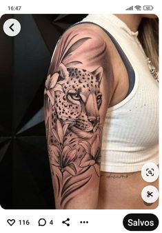 a black and white photo of a woman's arm with a leopard tattoo on it