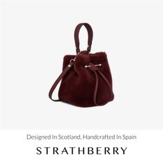 A modern take on the classic bucket bag, our best-selling osette is your perfect everyday companion. Deceptively spacious, the soft structure is handcrafted in spain and features an elegant drawstring closure, complete with our signature music bar. This compact yet versatile silhouette can be carried in hand by the leather top-handle, or styled as a crossbody bag with the detachable leather strap - for elegant ease in your everyday. Indulge in the cosy embrace of our shearling bag collection, a Elegant Evening Shoulder Bag With Faux Fur Lining, Elegant Evening Bags With Faux Fur Lining, Leather Bag With Faux Fur Lining, Luxury Winter Shoulder Bag For Everyday Use, Luxury Bags With Faux Fur Lining For Everyday Use, Luxury Shoulder Bag For Everyday Winter Use, Elegant Shoulder Bag With Loop Closure For Daily Use, Elegant Daily Use Bag With Loop Closure, Shearling Bag