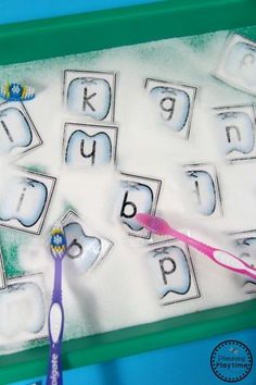 a toothbrush sitting on top of a tray filled with letters