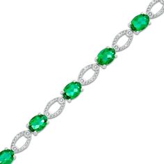 So luxe and lovely, she'll turn to this eye-catching fashion bracelet for every special occasion. Crafted in sterling silver, this engaging design features 7.0 x 5.0mm oval-shaped lab-created bright green emeralds alternating with diamond-accented open oval-shaped links. A look that proclaims her sophisticated style, this 7.5-inch bracelet is buffed to a brilliant luster and secures with a durable lobster claw clasp. Oval Sterling Silver Bracelet Fine Jewelry, Oval Sterling Silver Bracelet, Elegant Green Oval Diamond Bracelet, Classic Sterling Silver Bracelet With Oval Gemstone, Classic Sterling Silver Oval Gemstone Bracelet, Elegant Sterling Silver Bracelet With Oval Gemstone, Elegant Sterling Silver Oval Gemstone Bracelet, Classic Oval Gemstone Sterling Silver Bracelet, Sterling Silver Oval Jubilee Bracelet In Fine Jewelry Style