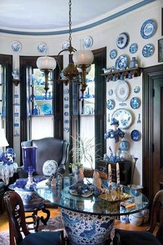 a dining room with blue and white plates on the wall